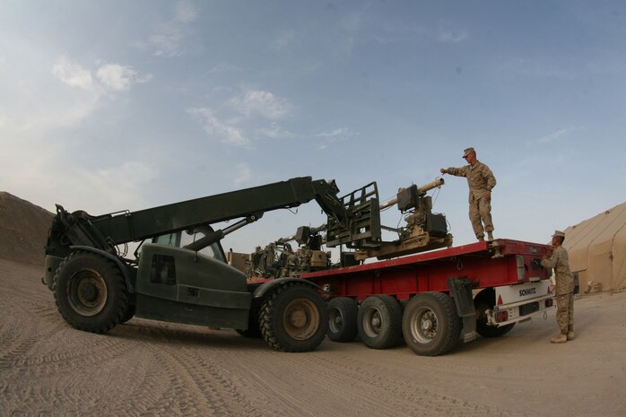 Marines with 2nd Maintenance Battalion (-) Reinforced, Combat Logistics Regiment 27 (Forward), load an oversized floodlight set onto a flatbed truck at Camp Al Taqaddum, Iraq, Oct. 21, 2009.  Marines and sailors with CLR-27 (Fwd) are currently in the process of completing a responsible drawdown to remove equipment and gear out of Iraq by the summer of 2010. (U.S. Marine Corps photograph by Gunnery Sgt. Katesha Washington)