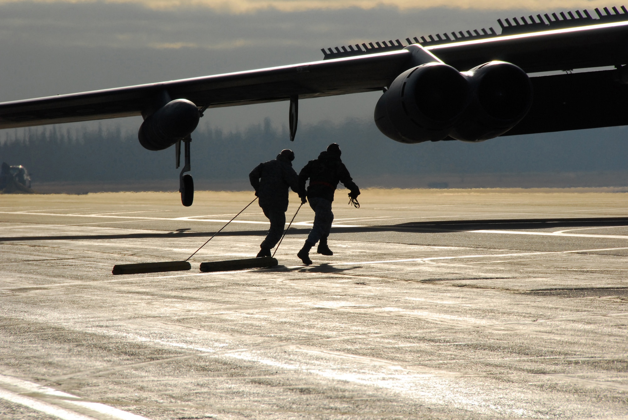 23rd Bomber Squadron weapon system specialists run to a B-52 Stratofortress to conduct a safety inspecting for hung flares following a training mission during RED FLAG-Alaska 10-1, Oct. 15, 2009, Eielson Air Force Base, Alaska. RF-A provides participants 67,000 square miles of airspace, more than 30 threat simulators, one conventional bombing range and two tactical bombing ranges containing more than 400 different types of targets. The B-52s, aircrew and support personnel are assigned to Minot AFB, N.D. (U.S. Air Force photo/Tech. Sgt. Shad Eidson)