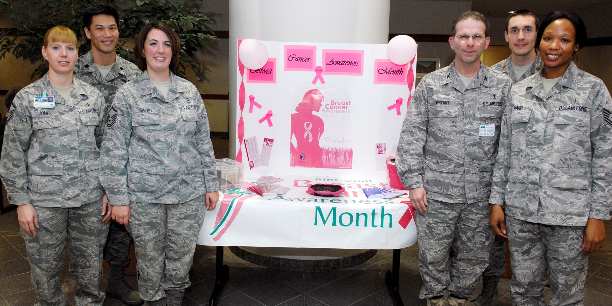 ELMENDORF AIR FORCE BASE, Alaska -- From left to right Master Sgt. Christy Jones, Lt. Col. Aaron Yu, Master Sgt. Brandy Galko, Col. Leslie Bryant, Maj. Leslie Bryant, and Tech. Sgt. Jamekia Ward, 3rd Medical Group stand in the hospital lobby during breast cancer awareness month. They were there to remind patients to schedule an appointment for an examination.(U.S. Air Force photo/ Airman Jack Sanders) 
