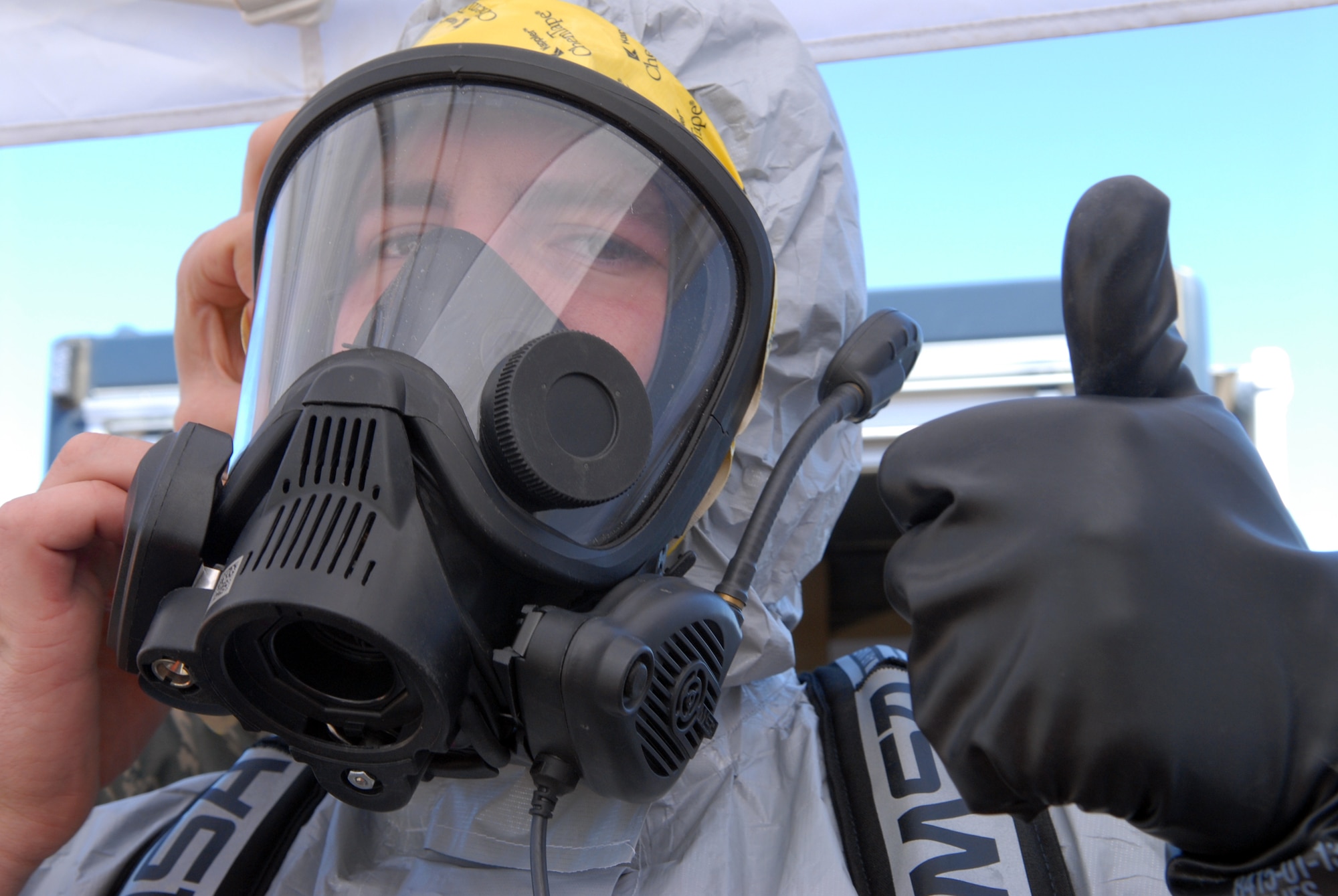 VANDENBERG AIR FORCE BASE, Calif. - Signaling a thumbs up, Senior Airman Patrick McKee, of the 30th Civil Engineer Squadron, gears up in a hazmat suit in order to proceed with an exercise here Tuesday, Oct. 20, 2009. The annual Emergency Operations Staff Assistant Visit exercise was preformed as preparation for the yearly visit of the Inspector General. (U.S. Air Force photo/Airman 1st Class Angelina Drake)
