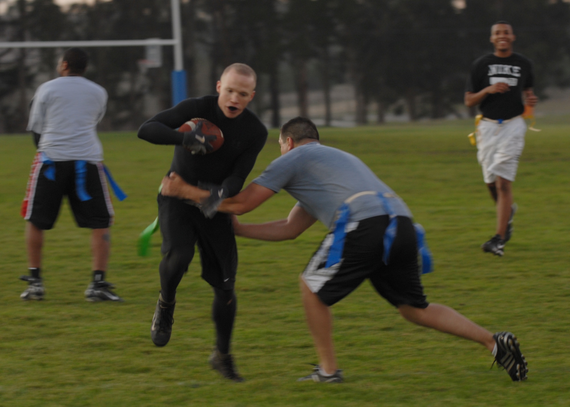 VANDENBERG AIR FORCE BASE, Calif. - Launch Group lineman, 1st Lt. Nikilaus Pleisch, rushes through defenders during an intramural flag football game on Tuesday Oct. 20, 2009 here.  The 14th Air Force came out on top 18-7, with a win over the Launch Group. For more information on intramural sports call the base fitness center at 805-606-3832. (U.S. Air Force photo/Senior Airman Antoinette Lyons)



