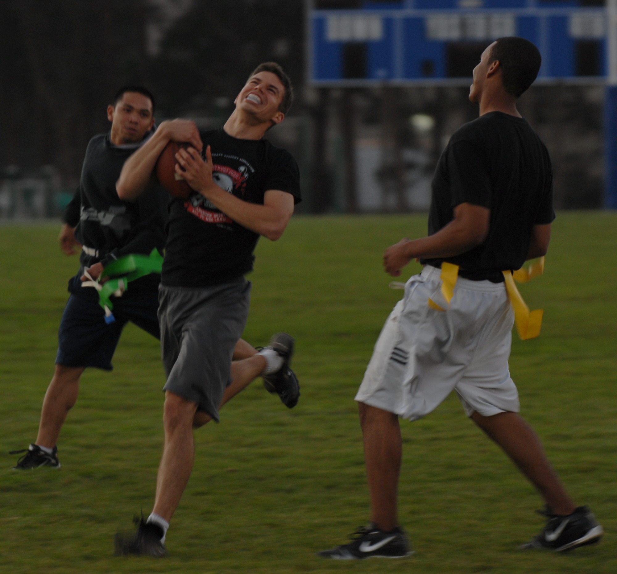VANDENBERG AIR FORCE BASE, Calif. - Headed toward the sideline, 2nd Lt. Brian Crouse, tries to gain yards as his flags are pulled by the 14th Air Force defense at an intramural flag football game on Tuesday, Oct. 20, 2009 here.  The 14th Air Force came out on top 18-7, with a win over the Launch Group. For more information on intramural sports call the base fitness center at 805-606-3832. (U.S. Air Force photo/Senior Airman Antoinette Lyons)



