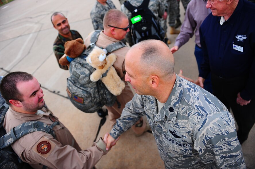DYESS AIR FORCE BASE, Texas -- Lieutenant Colonel Charles Howard greets Airmen as they return to Dyess Air Force Base from a six month deployment here Oct. 20.  The Airmen are from the 317th Airlift Group who flew and maintained C-130 Hercules Aircraft in support of Operations Enduring and Iraqi Freedom. (U.S. Air Force photo by Senior Airman Stephen Reyes)