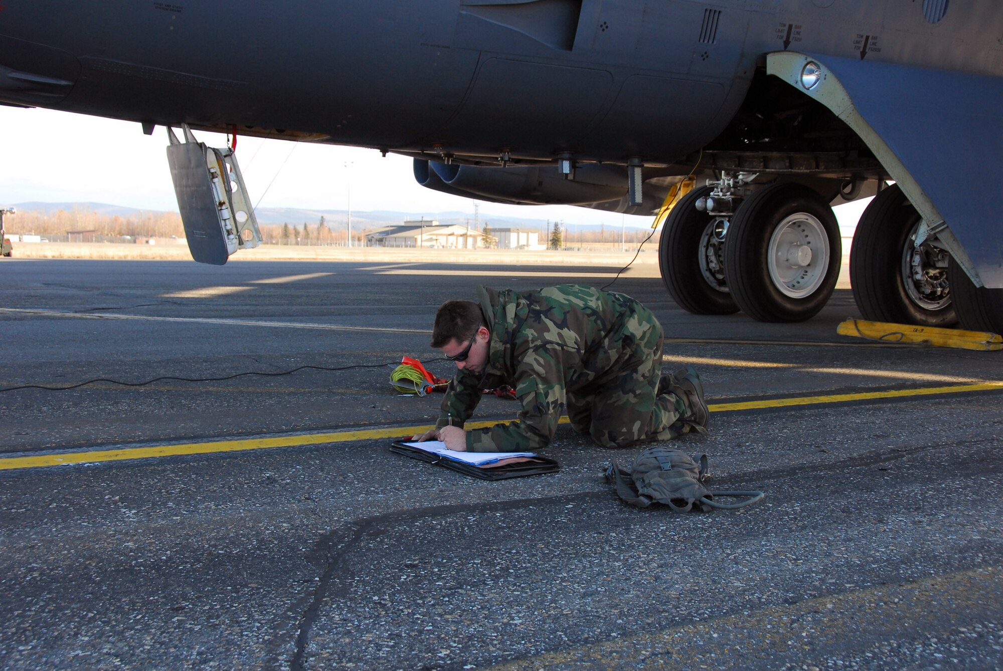 Senior Airman Chris Poulos updates a B-52 Stratofortress's maintenance forms during a quick turn inspection following a training mission at RED FLAG-Alaska 10-1 Oct. 15, 2009, Eielson Air Force Base, Alaska. He is an assistant dedicated crew chief assigned to the 23rd Bomber Squadron, Minot Air Force Base, N.D. RF-A is a Pacific Air Forces-directed field training exercise for U.S. and coalition forces under simulated combat conditions. (U.S. Air Force photo/Tech. Sgt. Shad Eidson) 