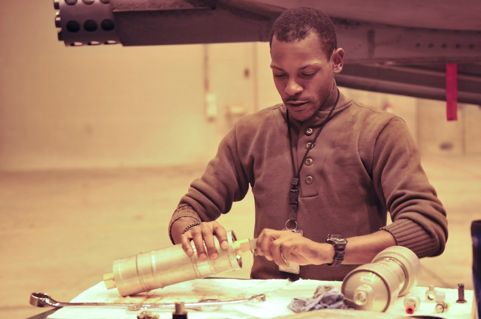 Staff Sgt. Justin Archer, a dedicated crew chief from the 51st Maintenance Squadron in Osan Air Force Base, Korea, fixes a broken part from the A-10 Thunderbolt II behind him. Sergeant Archer, a Binghamton, N.Y. native has served in the Air Force for 12 years. Sergeant Archer and the other maintainers are on a tour of duty here at Eielson for the RED FLAG-Alaska exercise. (U.S. Air Force photo/Airman 1st Class Janine Thibault)