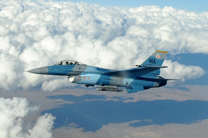 NELLIS AIR FORCE BASE, Nev.-- An F-16 Fighting Falcon Aggressor flies over the Nevada Test and Training Range after being refueled by an Ohio Air National Guard KC-135 Stratotanker Oct. 19, 2009. Red Flag 10-01 is a realistic combat training exercise involving the air forces of the United States and its allies. The exercise is conducted on the 15,000-square-mile Nevada Test and Training Range, north of Las Vegas. 
(U.S. Air Force Photo by Airman 1st Class Jamie Nicley)