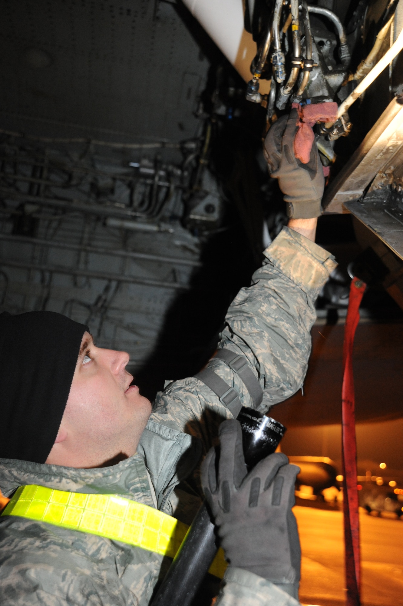 Staff Sgt. Fredrick Downing, 22nd Aircraft Maintenance Squadron, examines a KC-135 Stratotanker wheel well as part of a preflight inspection during a Nuclear Operational Readiness Inspection exercise at McConnell Air Force Base, Kan., Oct. 15, 2009. McConnell maintainers conduct general aircraft inspections before and after every flight. (U.S. Air Force photo/Tech. Sgt. Chyrece Campbell) 