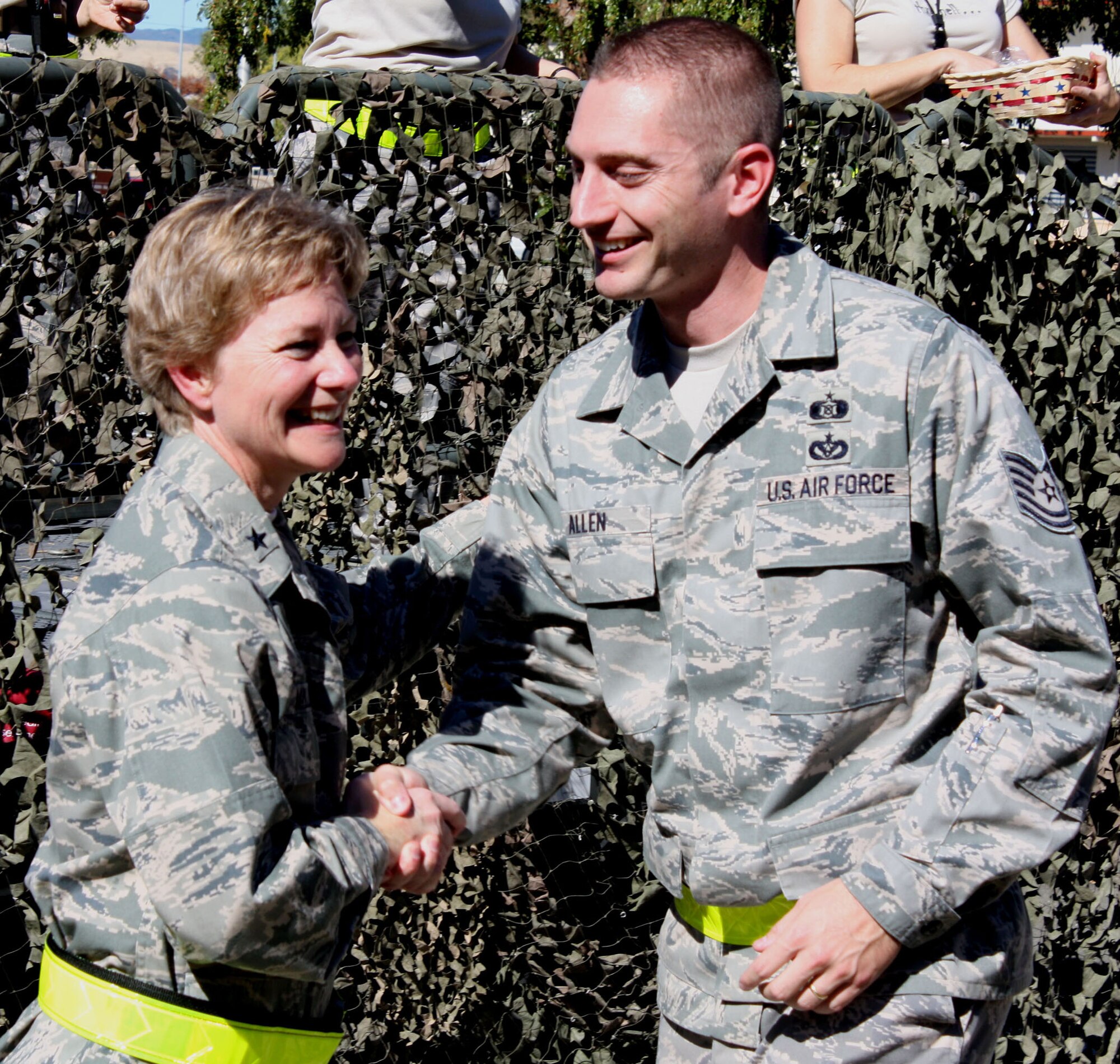 TRAVIS AIR FORCE BASE, Calif. -- Brig. Gen. Maryanne Miller, 349th Air Mobility Wing commander, 'coins' Tech. Sgt. Robert Allen, 349th Civil Engineer Squadron, at the wing Pep Rally Oct. 16, 2009. General Miller planned the rally, along with a barbeque picnic, to thank wing Airmen for all their hard work, long hours and preparation for the Team Travis Operational Readiness Inspection Oct. 17-24, in Alpena, Mich. These inspections test the capabilities of the active, Guard and Reserve Air Force to deploy and operate successfully, in austere battle conditions. (U.S. Air Force photo/SMSgt. Ellen Hatfield)