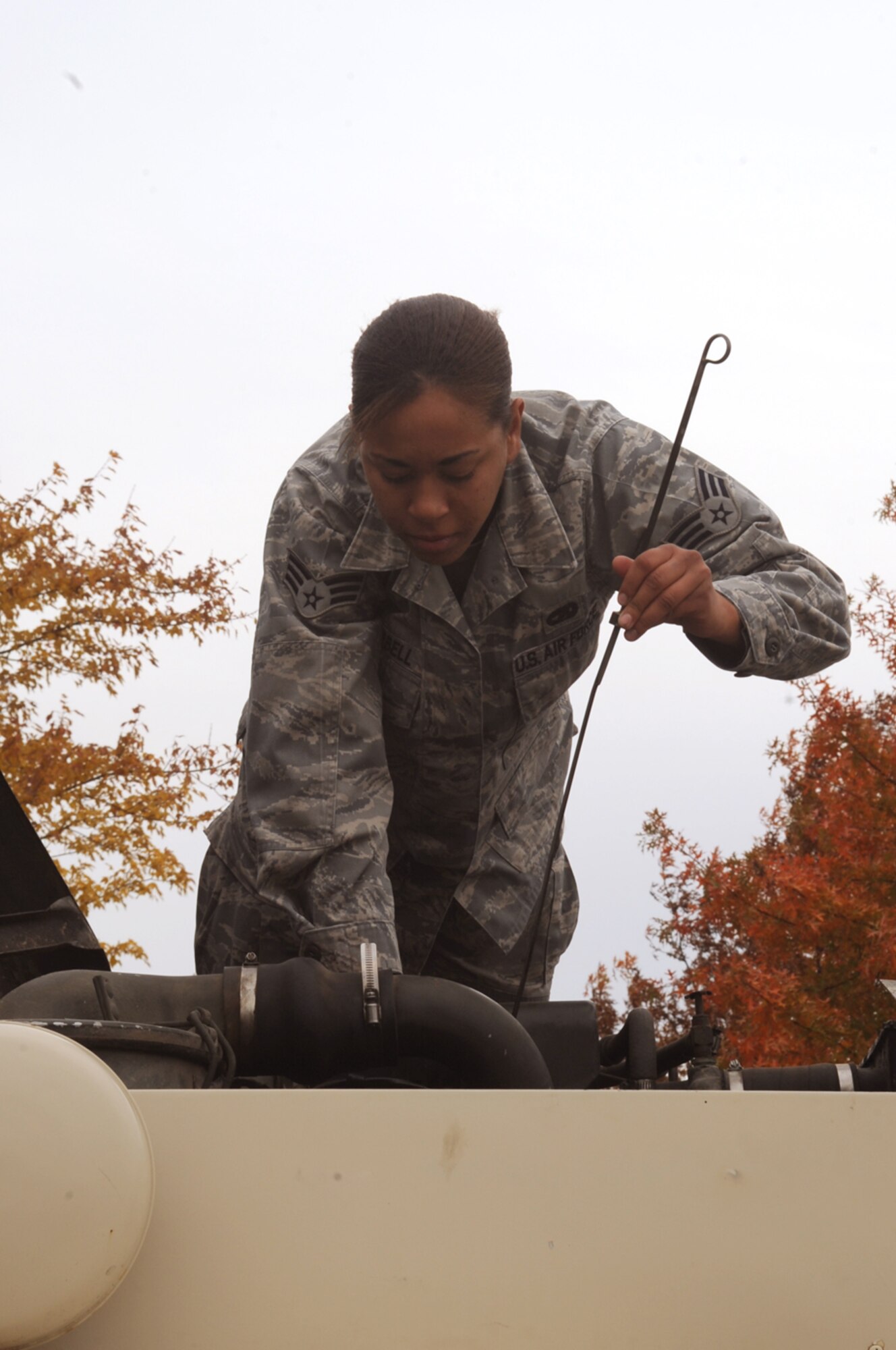 WHITEMAN AIR FORCE BASE, Mo. -- Senior Airman Kristin Campbell, 509th Logistics Readiness Squadron Vehicle Operator, withdraws the oil level indicator from a "deuce-and-a-half" truck before an assignment.  Operators must inspect thier equipment before each driving assignment.