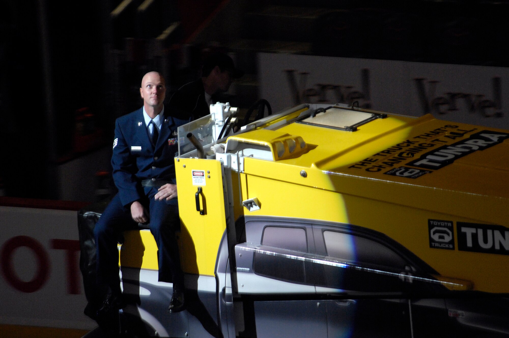 Staff Sgt Aaron Poirier, 56th Security Forces rides on a zamboni at the Jobing.Com Areana in Glendale, Arizona, Oct. 17, 2009. The events of that night are part of a bi-annual Phoenix Coyotes hockey team U.S. Armed Forces appreciation night. (U.S. Air Force Photo by Staff Sgt Jason Colbert)