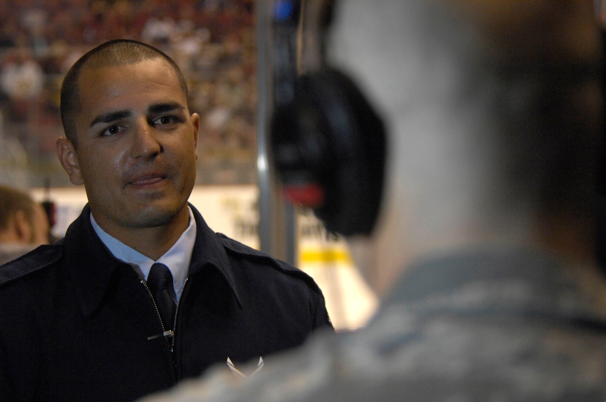 2nd Lt. Ryan De Camp, 56th Fighter Wing Deputy of Public Affiairs, interviews Senior Airman Gary Nelson, Luke Air Force Base Honor Guard, after having presented the colors with the rest of his detail at the Jobing.Com Areana in Glendale, Arizona, Oct. 17, 2009. The events of that night are part of a bi-annual Phoenix Coyotes hockey team U.S. Armed Forces appreciation night. (U.S. Air Force Photo by Staff Sgt Jason Colbert)