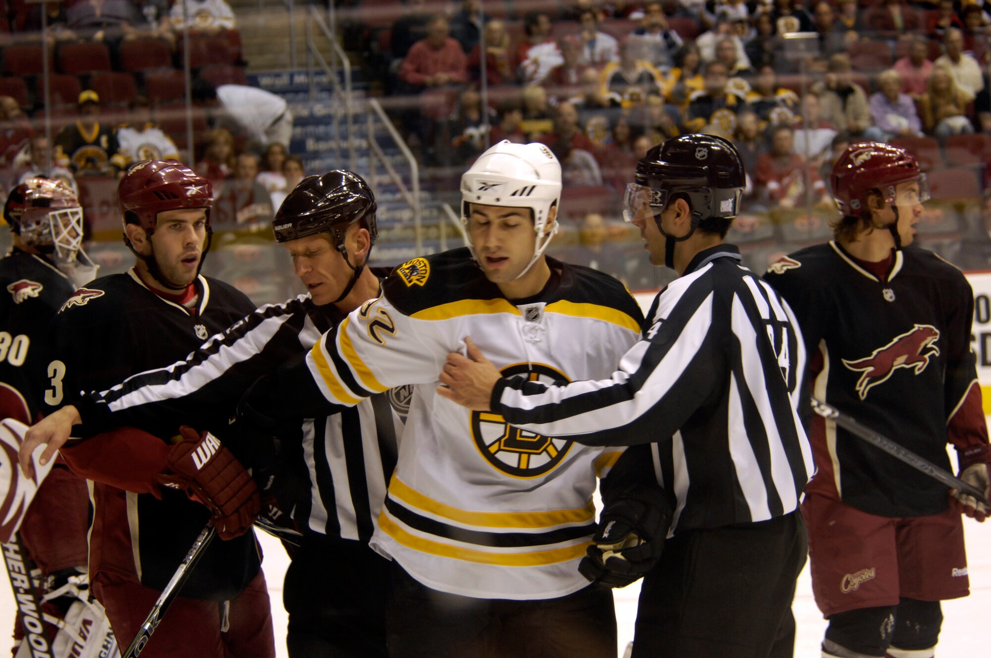 Referees seperate players during a hockey game at the Jobing.Com Areana in Glendale, Arizona, Oct. 17, 2009. (U.S. Air Force Photo by Staff Sgt Jason Colbert)