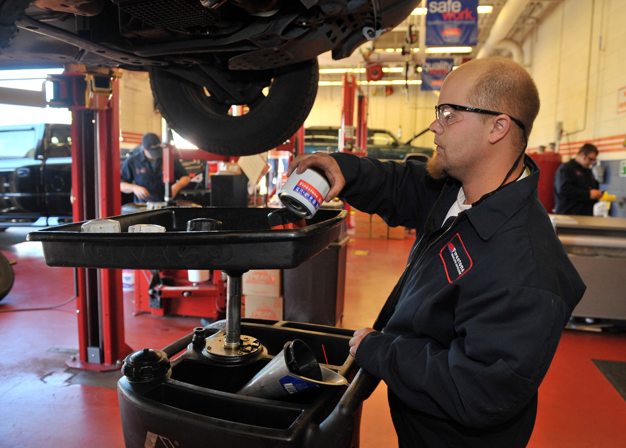 SHAW AIR FORCE BASE, S.C. -- Ronnie Yarbrough changes the oil of the day's first vehicle, Oct. 21. Firestone Car Care Centers are opening at 30 Army and Air Force Exchange Service locations across the United States. (U.S. Air Force photo/Senior Airman Kathrine McDowell) 