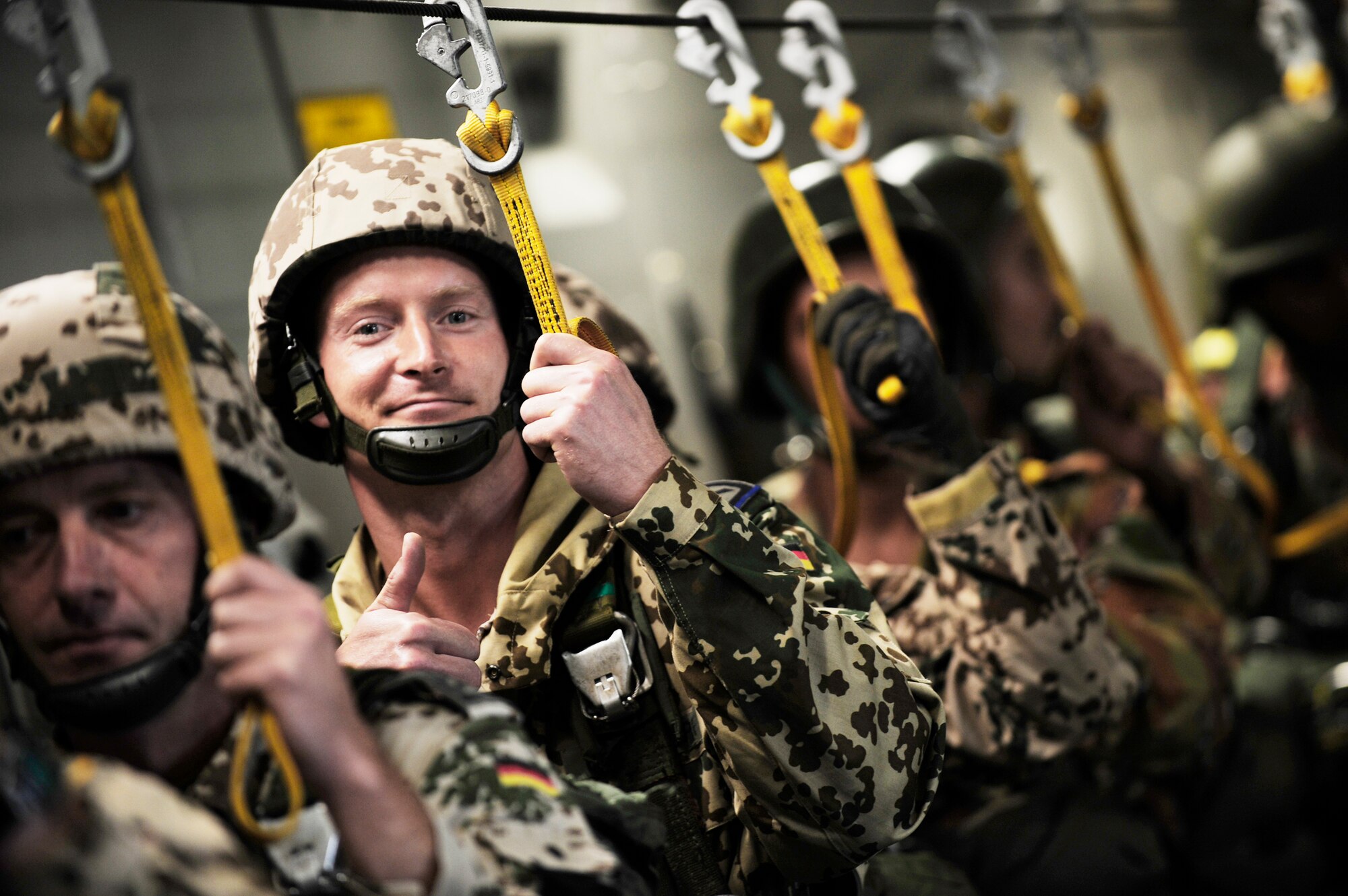 A German soldier gives a "thumbs up" as other paratroopers begin their jump Oct. 15, 2009 during Exercise Bright Star. The exercise is a joint international military airdrop that strengthens and enhances the cohesiveness of each country's participating forces. This year's participants include the United States, Egypt, Kuwait, Pakistan, Germany and Jordan. (U.S. Air Force photo/Staff Sgt. Jacob N. Bailey)