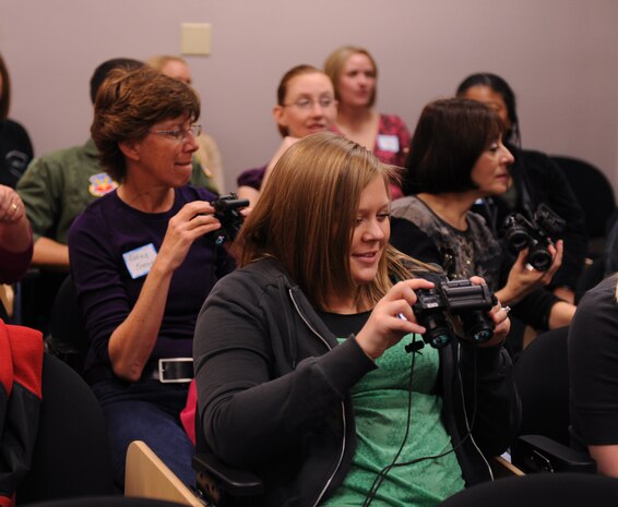 NELLIS AIR FORCE BASE Nev.-- Beth Bracklein, wife of Staff Sgt. Michael Bracklein, 66th Rescue Squadron air crew flight equipment craftsman, is briefed on the proper use of night vision goggles during a briefing before the spouse orientation flights.  Spouses of the 66th RQS, 58th RQS and 763rd Maintenance Squadron participated in orientation flights to become familiar with the training and the mission of the units.
(U.S. Air Force Photo Airman 1st Class Stephanie Rubi)