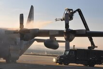 RAMSTEIN AIR BASE, Germany -- A ground crew member, deployed here in support of Operation Joint Enterprise, uses a vehicle known as a "Huffer" to de-ice a C-130 Hercules aircraft on the flightline here, Oct. 19, 2009. This aircraft will be used to transport troops and cargo throughout Europe, Africa and Centtral Commands. U.S. Air Force photo by Senior Airman Brenda Haines   
