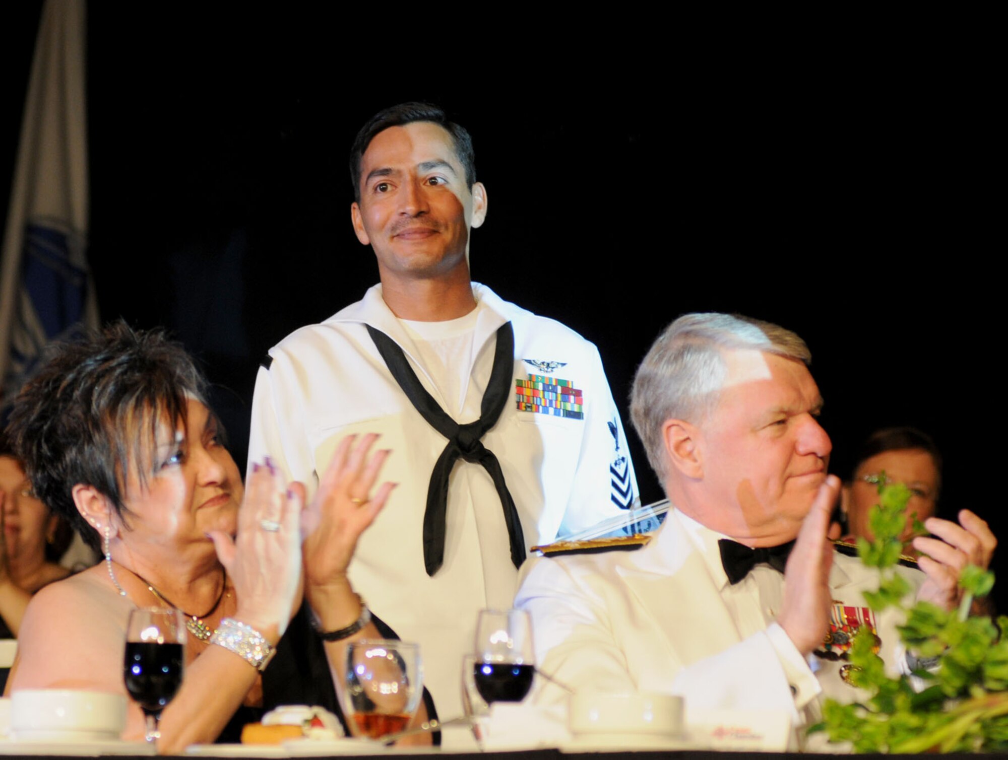 Margie McFarland, wife of Coast Chamber Chairman John McFarland of The Sun Herald, and Adm. Gary Roughead, chief of naval operations, applaud Petty Officer 1st Class Clarence Hartenstine II, recipient of the 2009 Thomas V. Fredian Community Leadership Award at the annual Salute to the Military, Oct. 13 at the Mississippi Coast Coliseum and Convention Center in Biloxi.  Petty Officer Hartenstine is an instructor and community service coordinator for the Keesler Center for Naval Aviation Technical Training Unit.  Admiral Roughead was the guest speaker for the annual event hosted by the Mississippi Gulf Coast Chamber of Commerce.  (U.S. Air Force photo by Kemberly Groue)