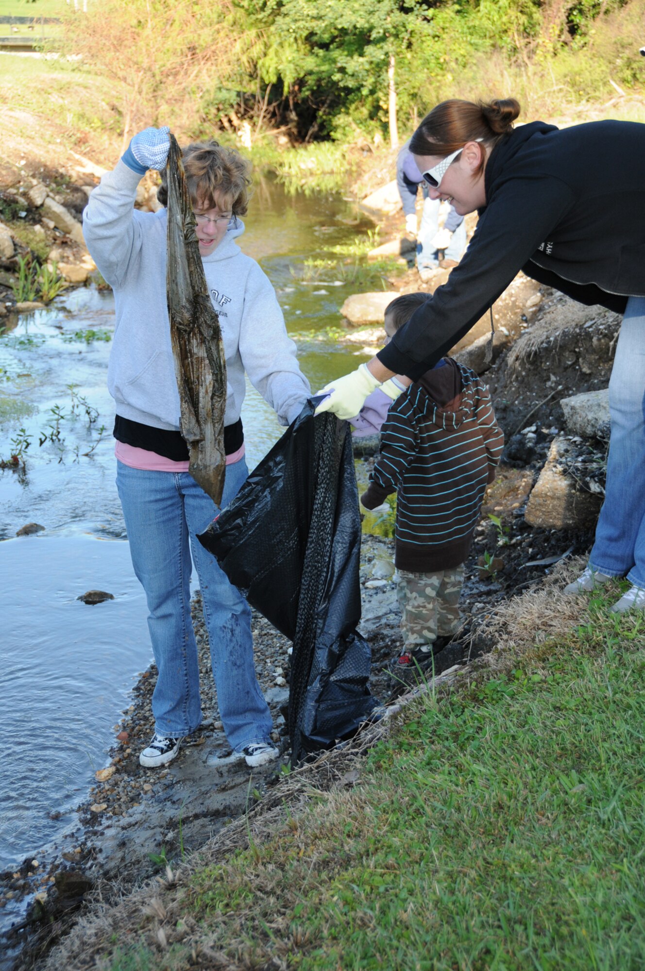 Keesler volunteers Laura Nestor, left, wife of Airman 1st Class Jordan Nestor, and Andi Hunter, wife of Tech. Sgt. Cory Hunter, bag a trash find at Hiller Park in Biloxi Oct. 17.  The women participated in Keesler’s cleaning of the park during the annual Mississippi Coastal Cleanup coordination by the Mississippi Department of Marine Resources. In total, about 2,300 volunteers scoured the entire coast to round up 142,235 pounds of trash on the 132 miles of south Mississippi waterways and barrier islands. Both women’s husbands are part of the 81st SFS deployed to the United Arab Emirates.  (U.S. Air Force photo by Kemberly Groue)