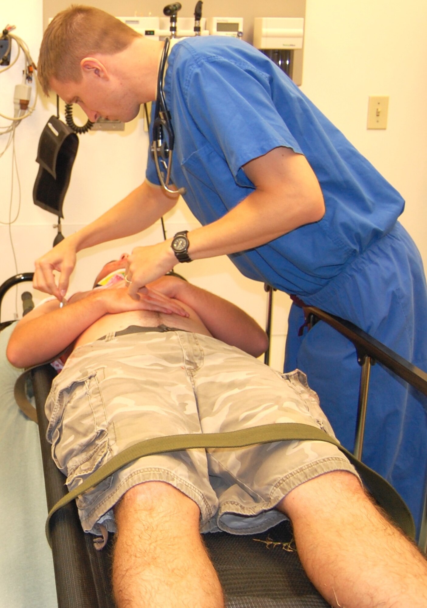 Maj. (Dr.) Stephen Boskovich, an emergency physician with the 81st Medical Operations Squadron, examines an accident victim in one of the emergency room’s trauma rooms. (U.S. Air Force photo by Steve Pivnick)