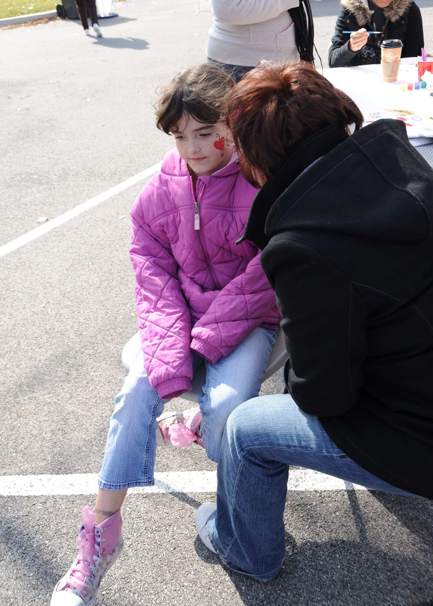 Scott AFB, Ill,; Kayla Council is getting her face painted at the Fall Festival. The festival helped kids and parents get together to spend time with each other and it also helped kids to meet other kids and learn new things. (U.S. Air Force Photo by Airman 1st Class Tristin English)