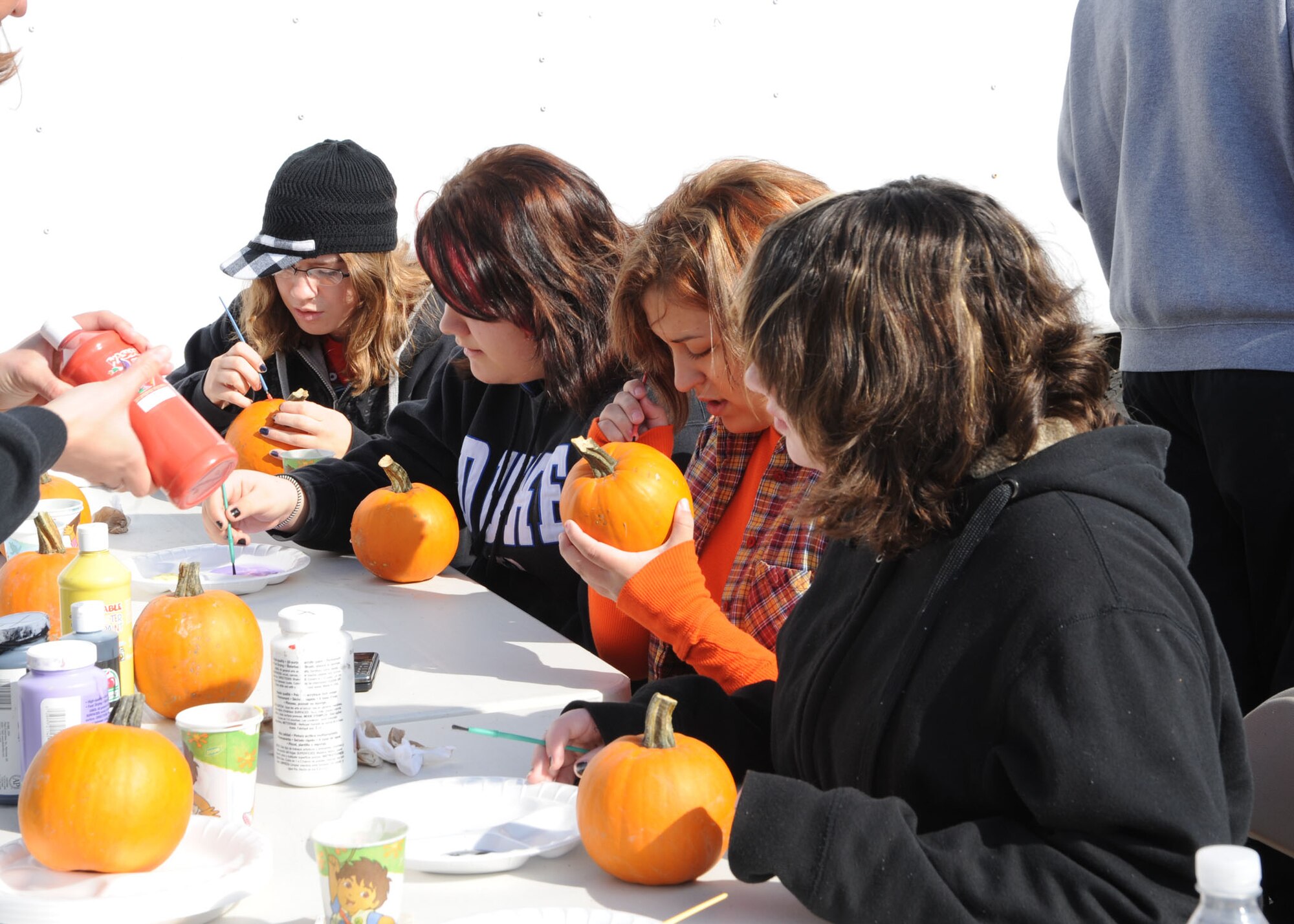 Scott AFB, Ill,; A group of girls are painting pumpkins at the festival. The festival was a family event with games, food and prizes.  (U.S. Air Force Photo by Airman 1st Class Tristin English)