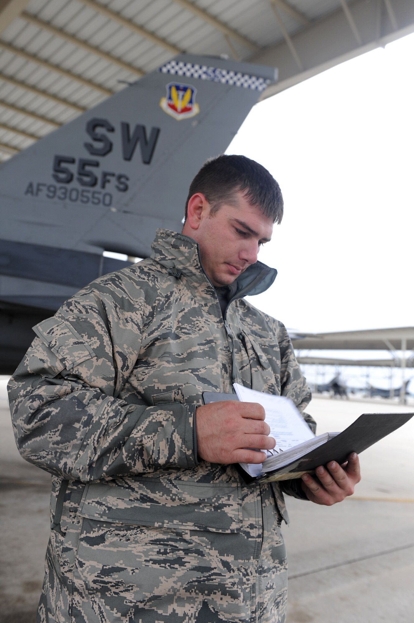SHAW AIR FORCE BASE, S.C. -- Senior Airman Nicholas Chapmon, 20th Aircraft Maintenance Squadron, checks his notes before preparing the jet for flight. Airmen of the 55th are departed for Las Vegas, Nev., to participate in a Red Flag exercise. (U.S. Air Force Photo/Senior Airman David Minor)