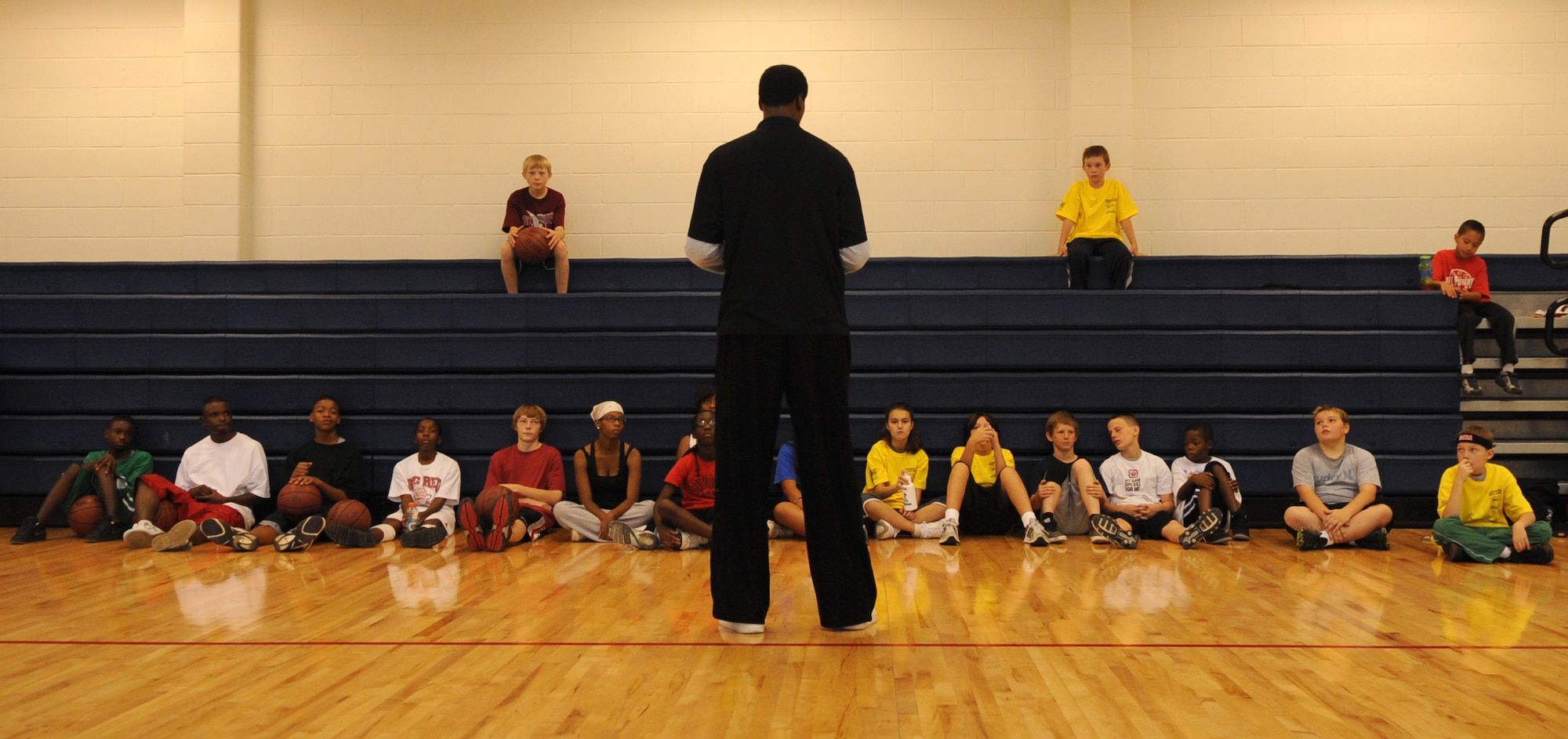 Ervin Johnson, former National Basketball Association player, speaks to 20 Buckley youths during a basketball clinic hosted by the 460th Force Support Squadron youth programs at the fitness center Oct. 17. (U.S. Air Force photo by Senior Airman John Easterling)