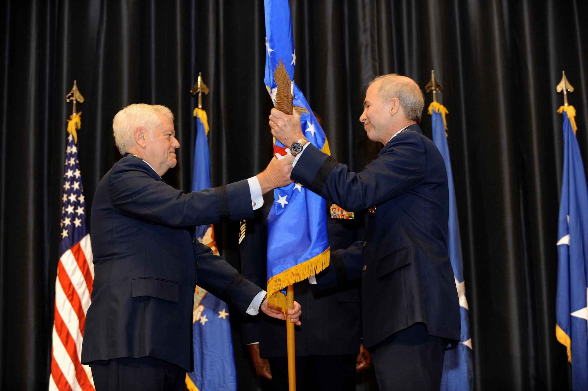 Brig. Gen. Richard T. Devereaux, U.S. Air Force Expeditionary Center commander, Joint Base McGuire-Dix-Lakehurst, takes the guidon from Gen. Arthur J. Lichte,  Air Mobility Command commander, Scott Air Force Base, Ill., during a change of command ceremony at the center on Oct. 19. "This is my dream job,” General Devereaux told his senior leaders later at his first staff meeting. (U.S. Air Force Photo/Carlos Cintron)
