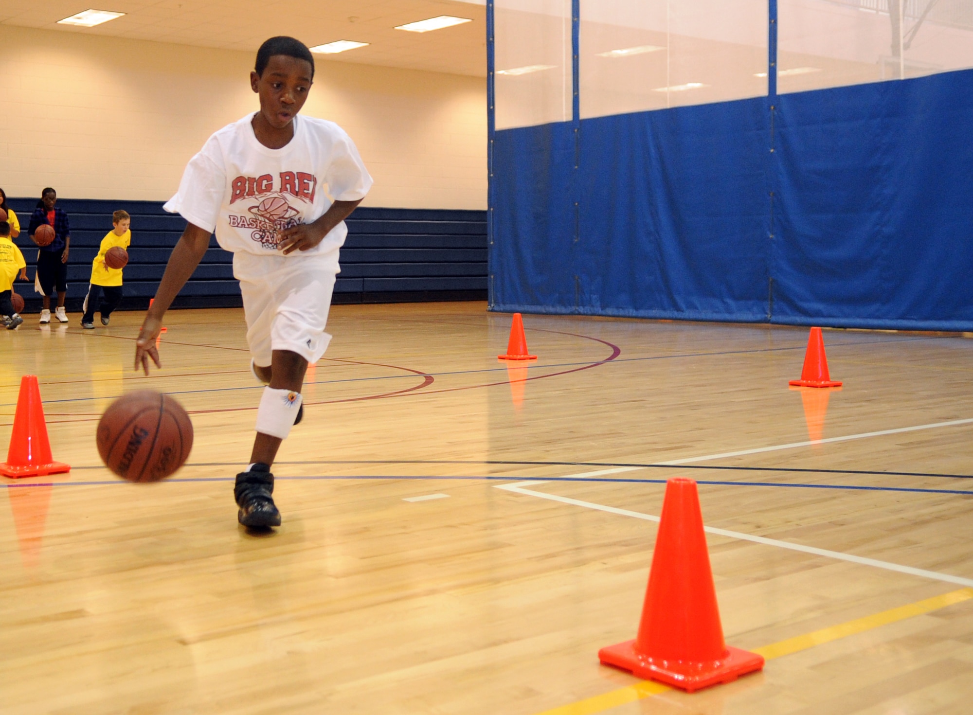 Tayveon Jordan dribbles through a drill during a basketball clinic hosted by the 460th Force Support Squadron at the fitness center Oct. 17. (U.S. Air Force photo by Senior Airman John Easterling)