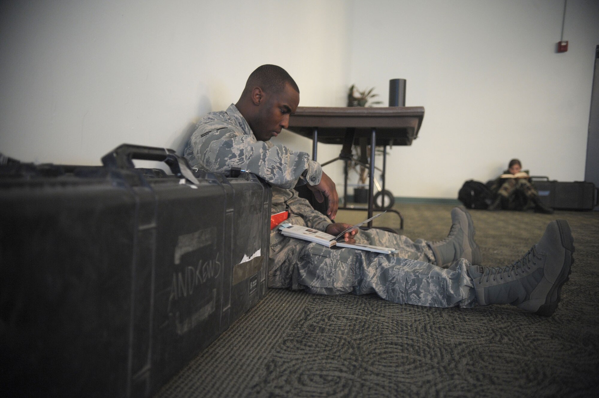 Senior Airman Zachary Brown, 89th Communications Squadron radio operator, reads his Airman's manual while waiting for his flight, Sunday, to Alpena, Michigan from Joint Base Andrews.  Airman Brown and other members of his team will be taking part in a 10 day exercise as part of their Operational Readiness Exercise.  (U.S. Air Force photo/Senior Airman Steven R. Doty) 