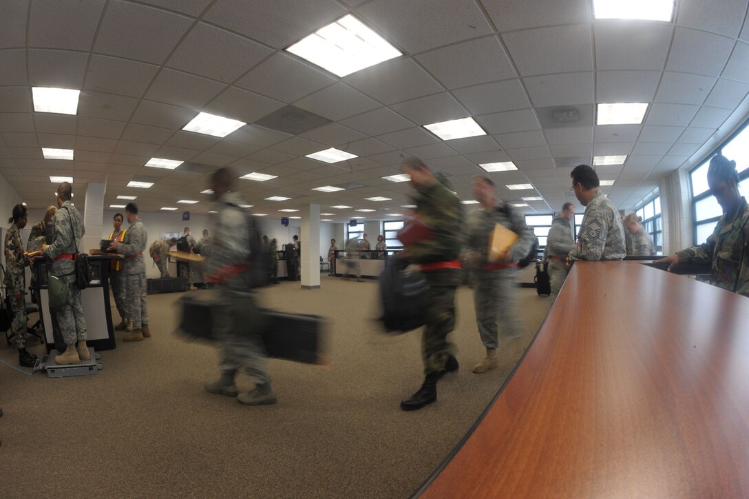 Airmen with the 89th Aerial Port Squadron process through Joint Base Andrews Installation Deployment Readiness Center (IDRC) prior to departure Sunday to Alpena, Michigan.  The 316th and the 79th Medical Wing took part in the 89th Airlift Wing Operational Readiness Inspection while processing a real world training mission for Lt. Col. Lee and his team.   (U.S. Air Force photo by Senior Airman Steven R. Doty)