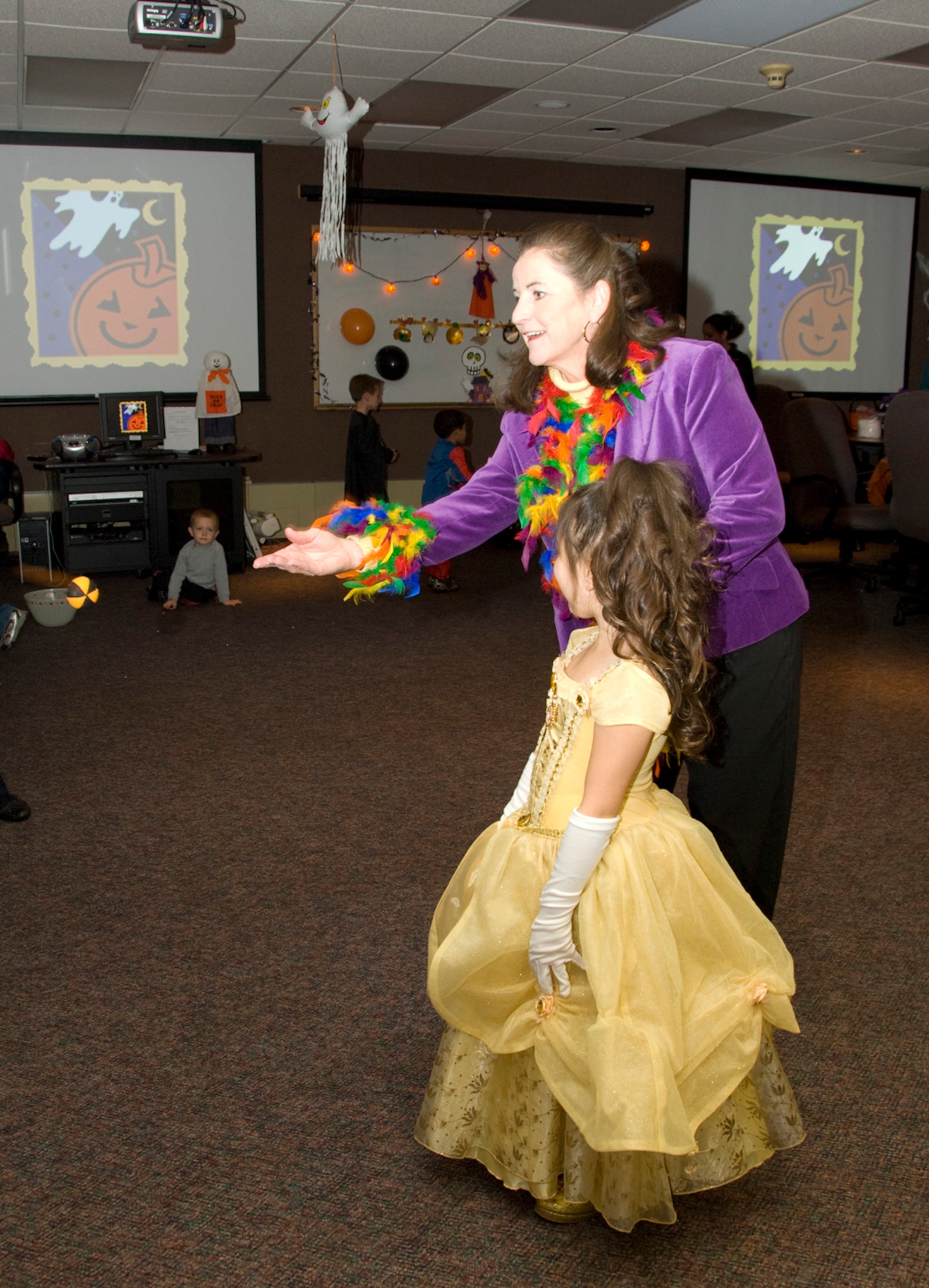HANSCOM AIR FORCE BASE, Mass. – Marcia Bowlds, wife of the Electronic Systems Center commander, plays a ghost ring toss game with Rebekah Murray at the Hearts Apart Halloween Party at the Airman and Family Readiness Center on Oct. 15.  Families of deployed military personnel were treated to an evening of fun Halloween activities at the event. The Hearts Apart Program offers support and activities for families that have loved ones deployed. For more information on the program contact the A&FRC at (781) 377-4222. (U.S. Air Force photo by Mark Herlihy)