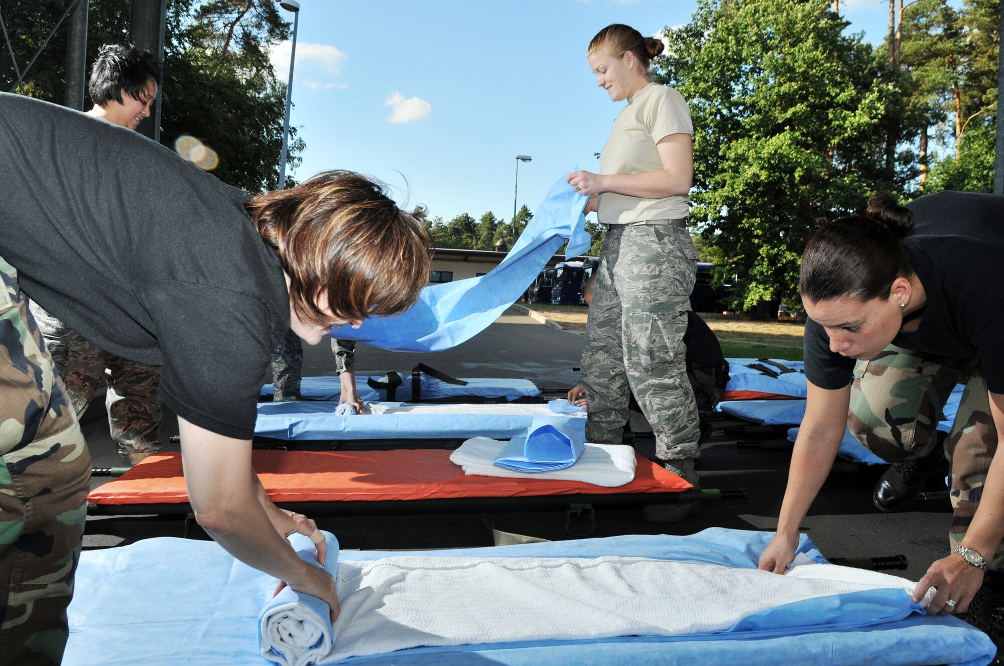 Tech. Sgt. Christina Werkin (from left to right starting in the front) , Tech. Sgt. Laura Small, Staff Sgt. Frances Sturdevant and Senior Airman Lisa Kennedy prepare gurneys Aug. 27, 2009, Ramstein Air Base, Germany. The gurneys will be used to transport wounded warriors to an aircraft taking them to Walter Reid Medical Center in Washington, D.C., for further medical treatment. The Airmen are 86th Contingency Aeromedical Staging Facility medical technicians. (U.S. Air Force photo/Senior Airman Nathan Lipscomb) 