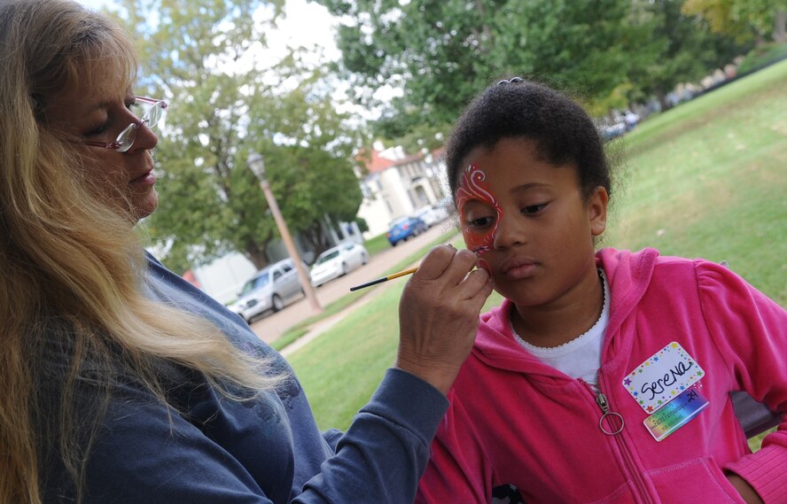 Serana Williams, 8, daughter of Tech. Sgt. Patrick Williams, 8th Air Force, gets has her face painted by Neecee Blackwell, an off-base vendor, during Celebrate Barksdale Oct. 16. Events included a 5K run, burger burn, contests for children and military members as well as a golf tournament and picnic. (U.S. Air Force photo by Senior Airman Alexandra Longfellow) (RELEASED)