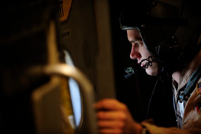Staff Sgt. Matt Cunningham looks out a paratroop door aboard a Charleston C-17 near Fort Bragg, N.C., during the preparation phase for Exercise Bright Star Oct. 8. Exercise Bright Star is a multi-national exercise conducted in Egypt. Sergeant Cunningham is a loadmaster assigned to the 14th Airlift Squadron. (U.S. Air Force photo/Staff Sgt. Jacob Bailey)