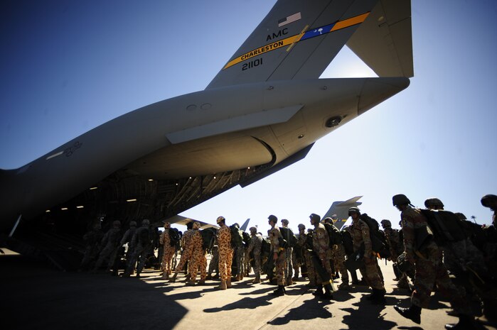 International soldiers board a Charleston C-17 at Pope AFB, N.C., during the preparation phase for Exercise Bright Star Oct. 8. Bright Star is a joint international military airdrop exercise whose purpose is to strengthen and enhance the cohesiveness of each country's participating forces. (U.S. Air Force photo/Staff Sgt. Jacob Bailey)