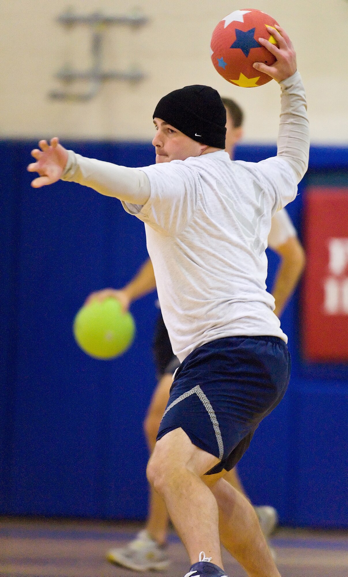 Capt. Bryce Benson, 9th Airlift Squadron, prepares to throw a dodge ball at his opponent in the Fitness Center gym Oct. 16 during Wing Sports Day. Team Dover Airmen participated in competitions including bowling, dodge ball and basketball. (U.S. Air Force photo/ Roland Balik)