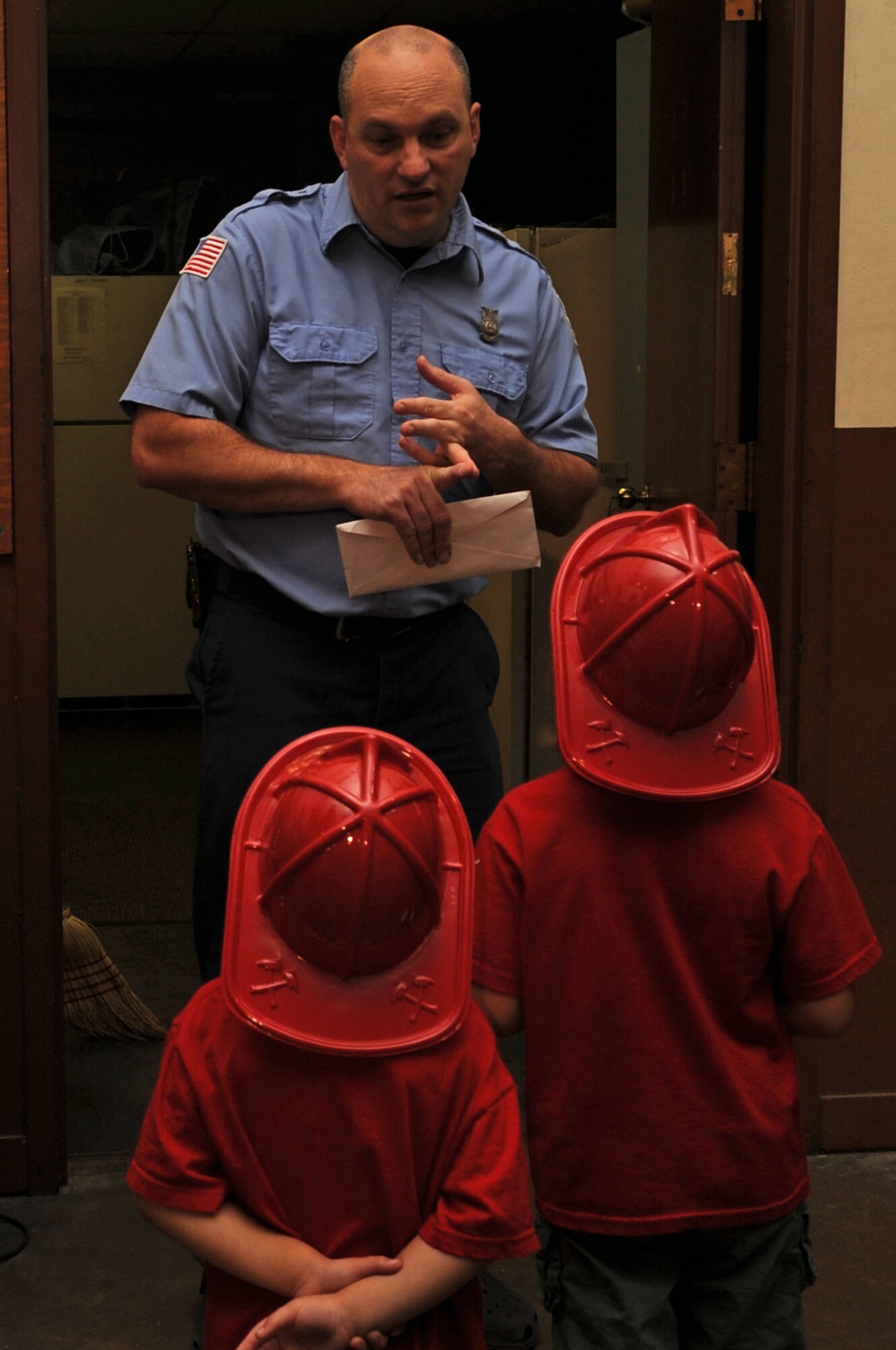 Jonathan Lynch, 2d Civil Engineer Squadron, Barksdale Fire Department station captain, talks to children about fire prevention during a tour at Barksdale fire station during fire prevention week. (United States Air Force photo/ Airman 1st Class Brittany Y. Bateman)(RELEASED)