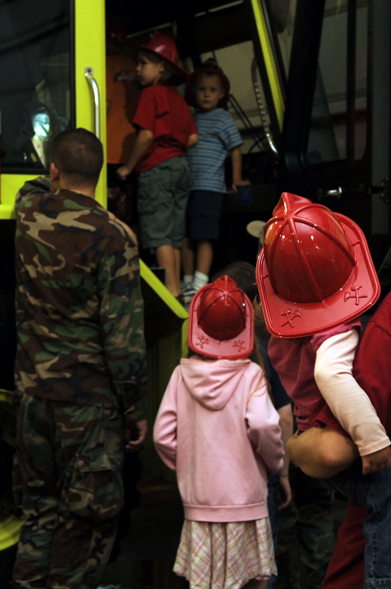 Children wait in line for a tour of one the of fire trucks while visting the Barksdale’s Fire Station during fire prevention week. (United States Air Force photo/ Airman 1st Class Brittany Y. Bateman)(RELEASED)