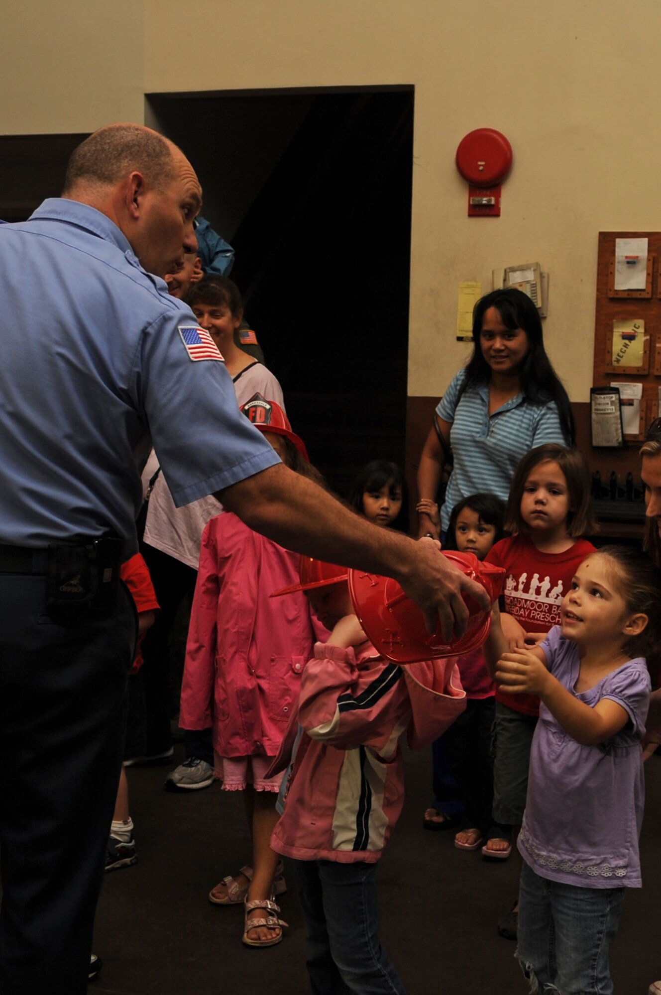 Lacey Ivacic, daughter of Senior Airman Ryan Ivacic, 2d Bomb Wing Public Affairs, receives a fireman hat from Jonathan Lynch, 2d Civil Engineer Squadron, Barksdale Fire Department station captain, during a visit at the Barksdale Fire Station. (United States Air Force photo/ Airman 1st Class Brittany Y. Bateman)(RELEASED)