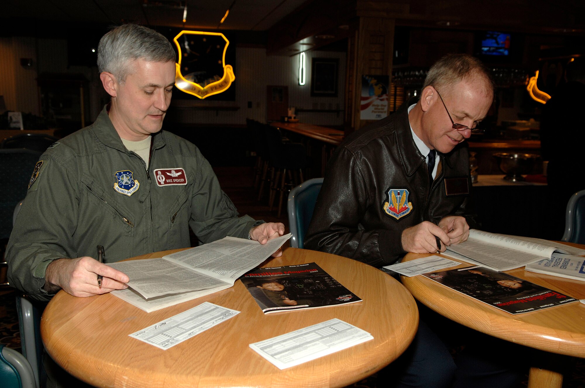 MINOT AIR FORCE BASE, N.D. -- Colonel Michael Spencer, 91st Missile Wing vice commander,  and Colonel Joel Westa, 5th Bomb Wing commander, research organizations for Combined Federal Campaign here Oct. 19.  Established in 1961, the CFC is the largest workplace charity campaign in the country and the only campaign authorized to solicit and collect contributions from federal employees in the workplace. (U.S. Air Force Photo by Senior Airman Matthew Smith)