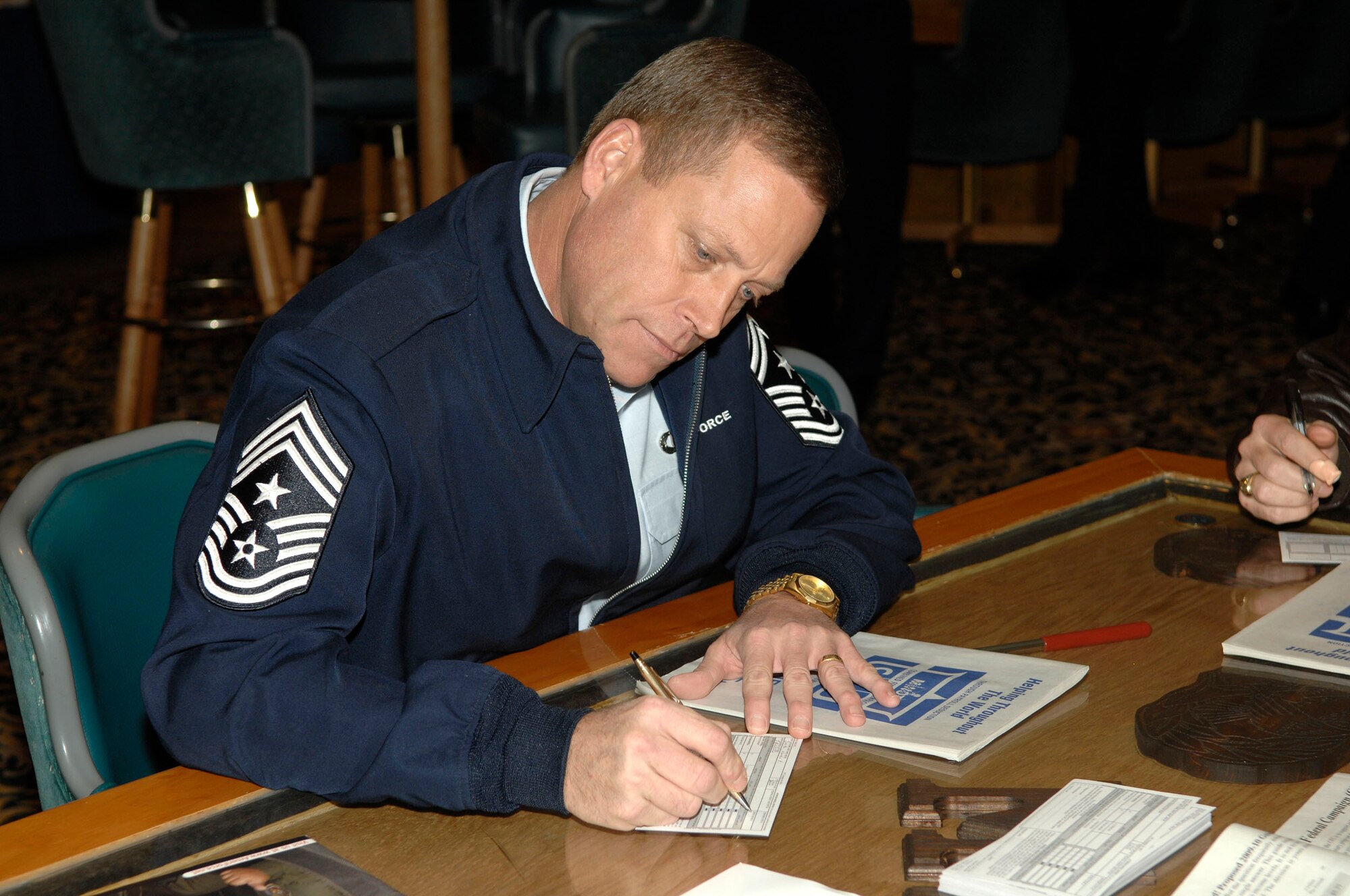 MINOT AIR FORCE BASE, N.D. -- Chief Master Sgt. Martin Smith, 5th Bomb Wing  command chief master sergeant,  fills out his pledge card for the Combined Federal Campaign here Oct. 19.  Established in 1961, the CFC is the largest workplace charity campaign in the country and the only campaign authorized to solicit and collect contributions from federal employees in the workplace. (U.S. Air Force Photo by Senior Airman Matthew Smith)