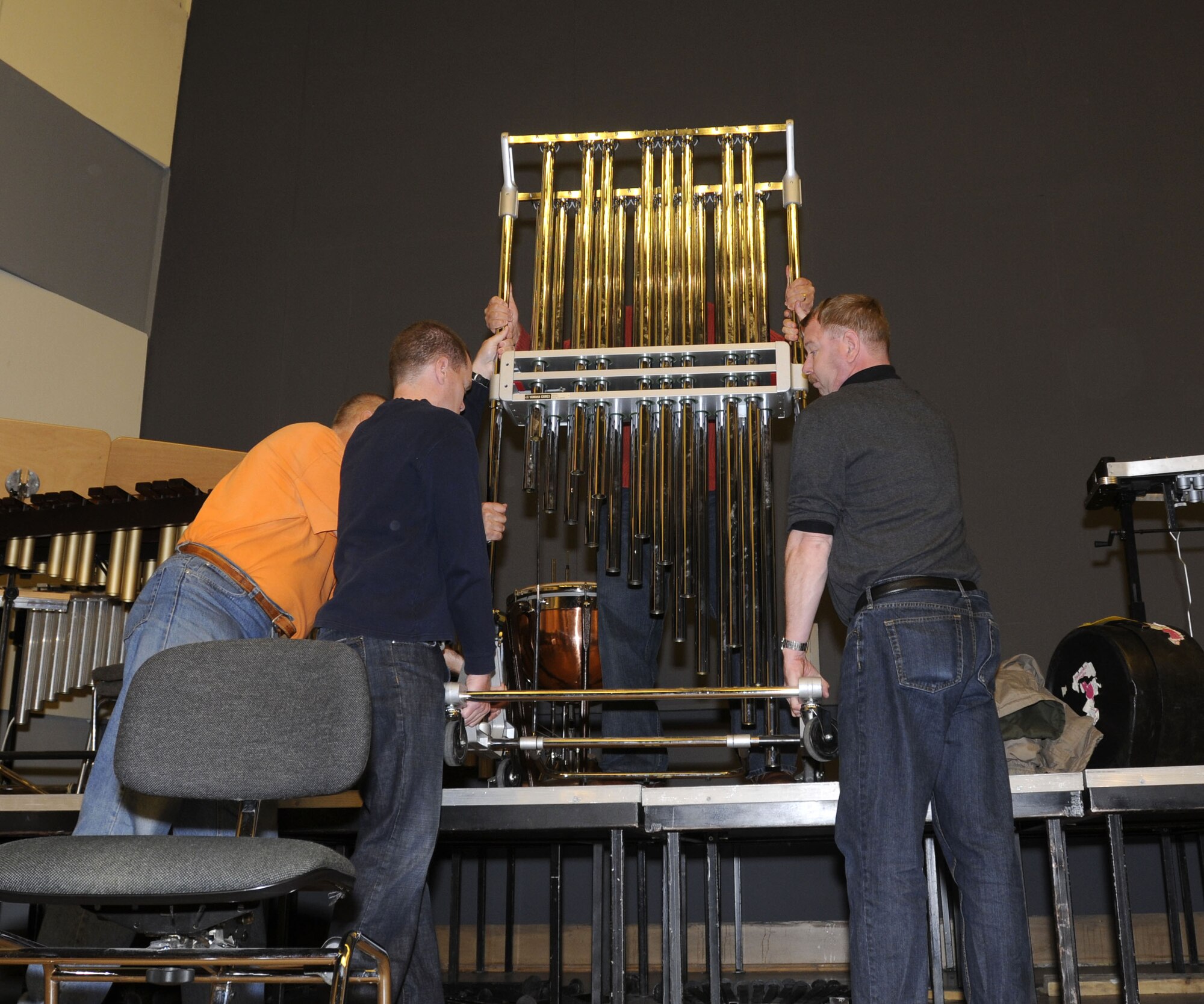 WROCLAW, Poland - Members of the U.S. Air Forces in Europe Band move chimes while setting up for their concert here at the Downbeat Filharmonia im. Witolda Lutoslawskiego Oct. 20.  The band sets up and tears down the stage for each concert.  The USAFE Concert Band will play six concerts in Poland in support of Gen. Roger Brady’s, USAFE commander, international outreach program in partnership with the U.S. State Department.  (U.S. Air Force photo/Master Sgt. Kelley J. Stewart)
