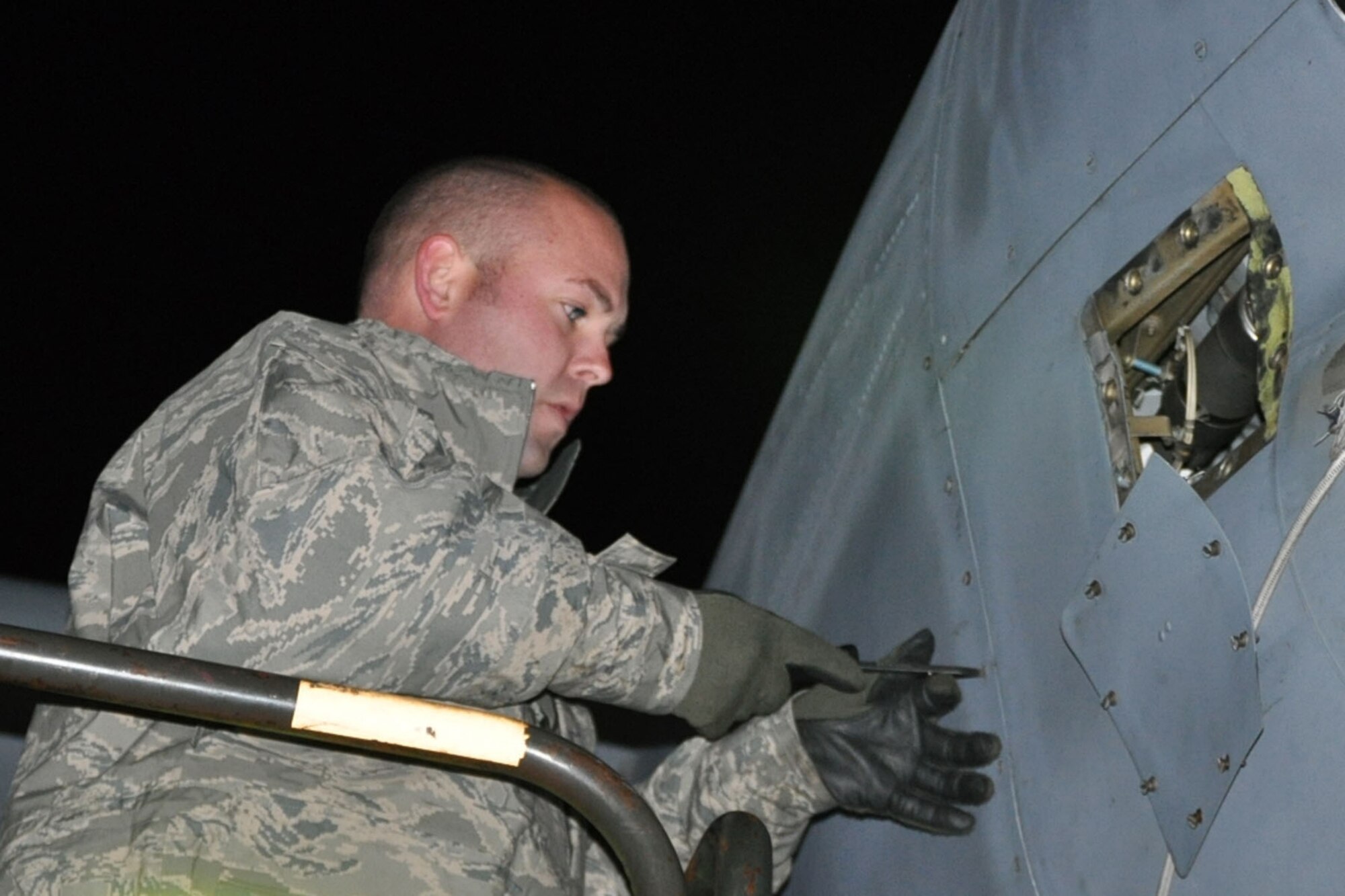 RAMSTEIN AIR BASE, Germany -- An Air Force Reserve aircraft mechanic assigned to the 910th Airlift Wing uses a screwdriver to remove an engine compartment access panel as part of a basic post-flight inspection of a C-130 Hercules aircraft on the flightline here, Oct. 20, 2009. The aircraft and its crew, from Youngstown Air Reserve Station, Ohio, returned from an airlift mission to Tel Aviv, Israel. The YARS Airmen are participating in a deployment here in support of Operation Joint Enterprise, which provides airlift support throughout Europe and Africa. U.S. Air Force photo by Senior Airman Brenda Haines