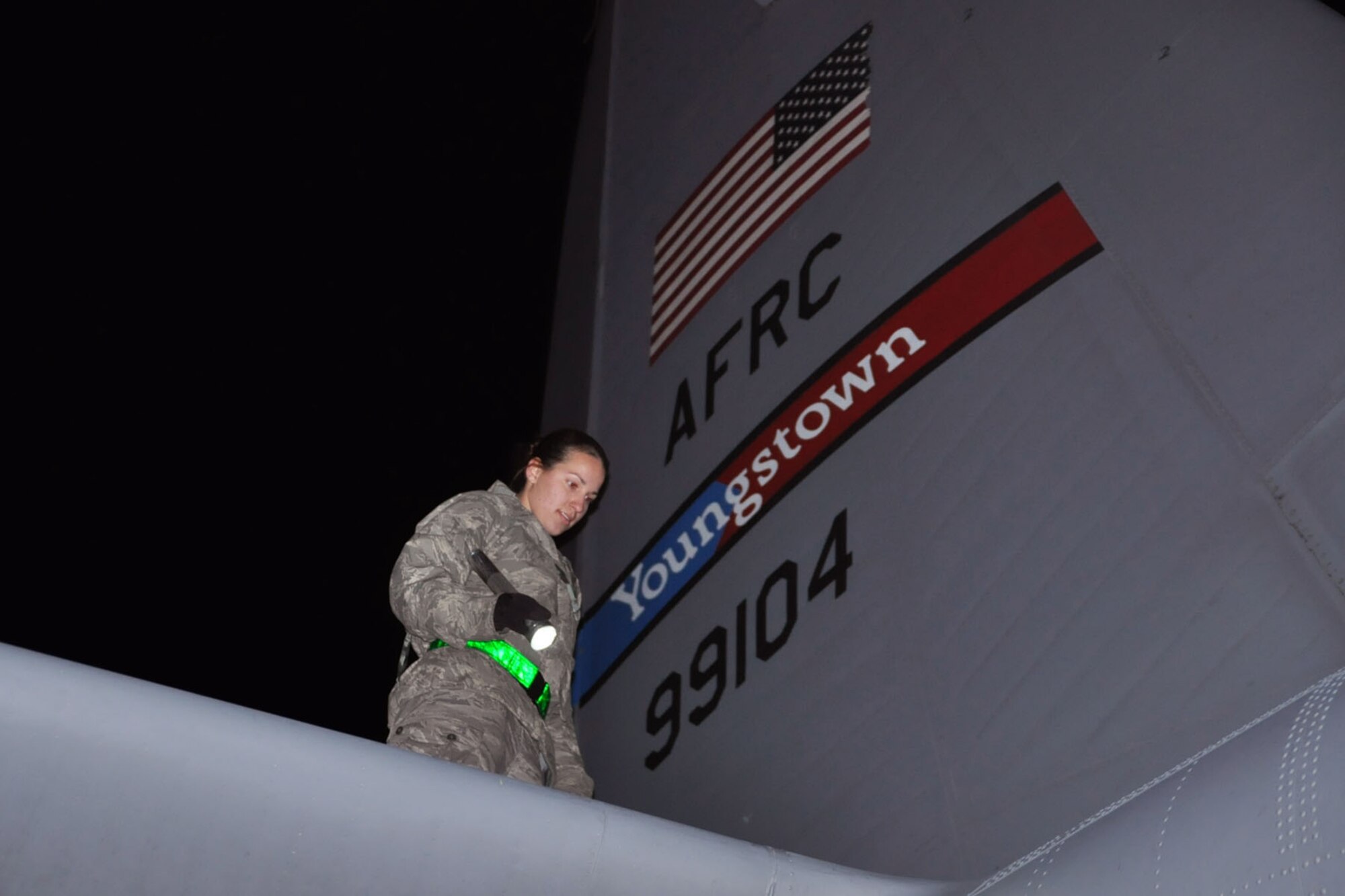 RAMSTEIN AIR BASE, Germany -- Air Force Reserve Staff Sgt. Rachele Sampson, an aircraft mechanic assigned to the 910th Maintenance Squadron, based at Youngstown Air Reserve Station, Ohio, uses a flashlight to perform her part of a basic post-flight inspection on a C-130H Hercules tactical cargo transport aircraft assigned to the 910th Airlift Wing, also based at YARS, on the flightline here, October 20, 2009. The aircraft returned to Ramstein Air Base after completing an airlift mission from Tel Aviv, Israel, hauling a cargo compartment full of supplies and equipment. Sergeant Sampson is checking the aircraft's fussealge, wing and stabilizer surfaces for cracks, defects, fluid leaks as well as burned-out exterior lights. The purpose of the basic post-flight inspection is to check the C-130 for any structural defects and mechanical or electrical failures or anything else not within operating standards for the aircraft. The YARS maintenance personnel, the C-130 and its crew are attached to the 38th Expeditionary Airlift Wing, base here, in support of Operation Joint Enterprise. More than 70 Airmen consisting of flight crews, maintenance personnel and support staff are currently attached to the 38th EAS with the airlift mission that will support locations in the U.S. Europe Command (EUROCOM), the U.S. Africa Command (AFRICOM) and the U.S. Central Command (CENTCOM) theaters of operations. U.S. Air Force photo by Master Sgt. Bob Barko Jr.      