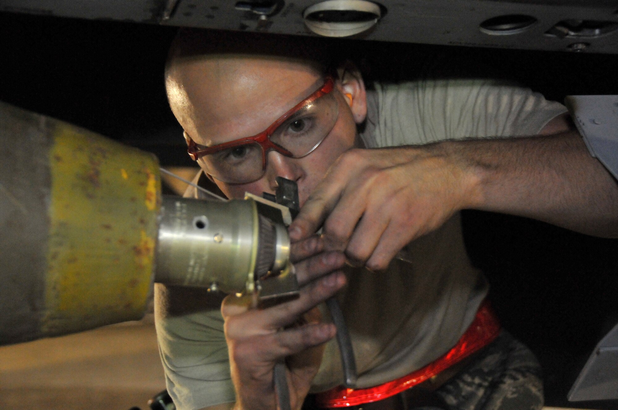 Senior Airman Derrick Pennington, weapons load crew member, secures a Mark 82 onto an F-15 at Kunsan Air Base, Republic of Korea, Sept. 17. Airman Pennington is assigned to the 389th Expeditionary Fighter Squadron, deployed from Mountain Home Air Force Base, Idaho. Throughout the week, 389th EFS weapons loaders like Airman Pennington, along with other Airmen and pilots, trained with live munitions. (U.S. Air Force photo/Capt. Shannon Collins) 