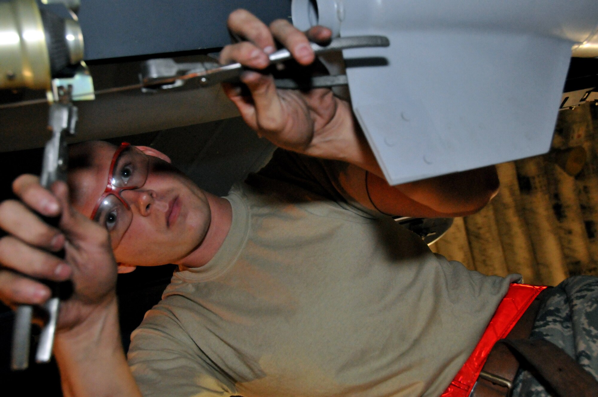 Senior Airman Derrick Pennington, weapons load crew member, secures a Mark 82 onto an F-15 at Kunsan Air Base, Republic of Korea, Sept. 17. Airman Pennington is assigned to the 389th Expeditionary Fighter Squadron, deployed from Mountain Home Air Force Base, Idaho. Throughout the week, 389th EFS weapons loaders like Airman Pennington, along with other Airmen and pilots, trained with live munitions. (U.S. Air Force photo/Capt. Shannon Collins) 