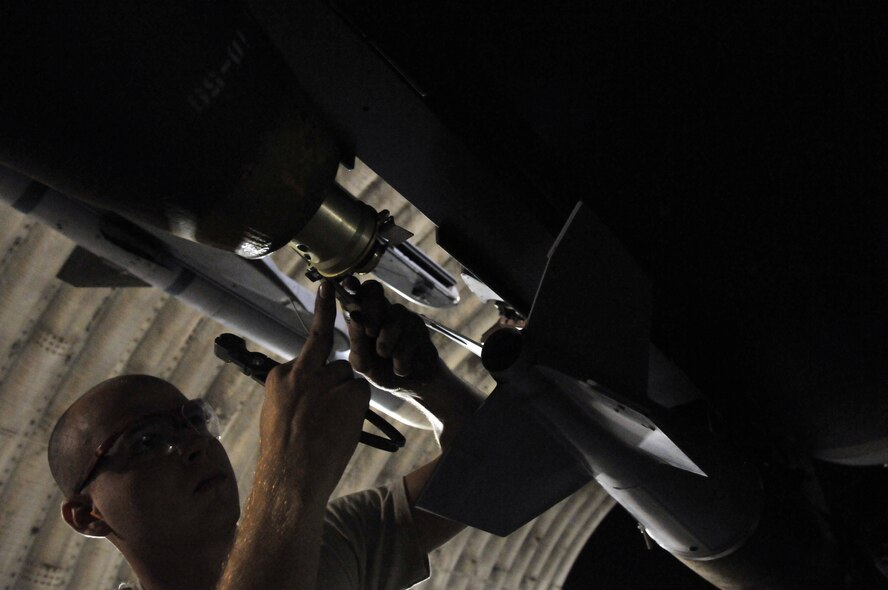 Senior Airman Derrick Pennington, weapons load crew member, secures a Mark 82 onto an F-15 at Kunsan Air Base, Republic of Korea, Sept. 17. Airman Pennington is assigned to the 389th Expeditionary Fighter Squadron, deployed from Mountain Home Air Force Base, Idaho. Throughout the week, 389th EFS weapons loaders like Airman Pennington, along with other Airmen and pilots, trained with live munitions. (U.S. Air Force photo/Capt. Shannon Collins) 
