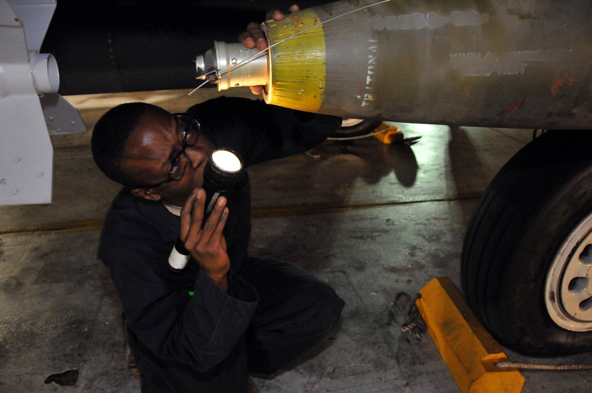 Staff Sgt. Dominique Battle, weapons load team chief, secures a Mark 82 onto an F-15 at Kunsan Air Base, Republic of Korea, Sept. 17. Sergeant Battle is assigned to the 389th Expeditionary Fighter Squadron, deployed from Mountain Home Air Force Base, Idaho. Throughout the week, 389th EFS weapons loaders like Airman Pennington, along with other Airmen and pilots, trained with live munitions. (U.S. Air Force photo/Capt. Shannon Collins) 