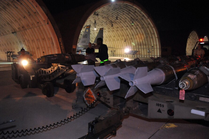 Staff Sgt. Dominique Battle, weapons load team chief, steadies the loading of a  Mark 82 onto a jammer driven by Airman 1st Class Ari Valdez, weapons load crew member, at Kunsan Air Base, Republic of Korea, Sept. 17. Sergeant Battle and Airman Valdez are assigned to the 389th Expeditionary Fighter Squadron, deployed from Mountain Home Air Force Base, Idaho. Throughout the week, 389th EFS weapons loaders, along with other Airmen and pilots, trained with live munitions. (U.S. Air Force photo/Capt. Shannon Collins) 